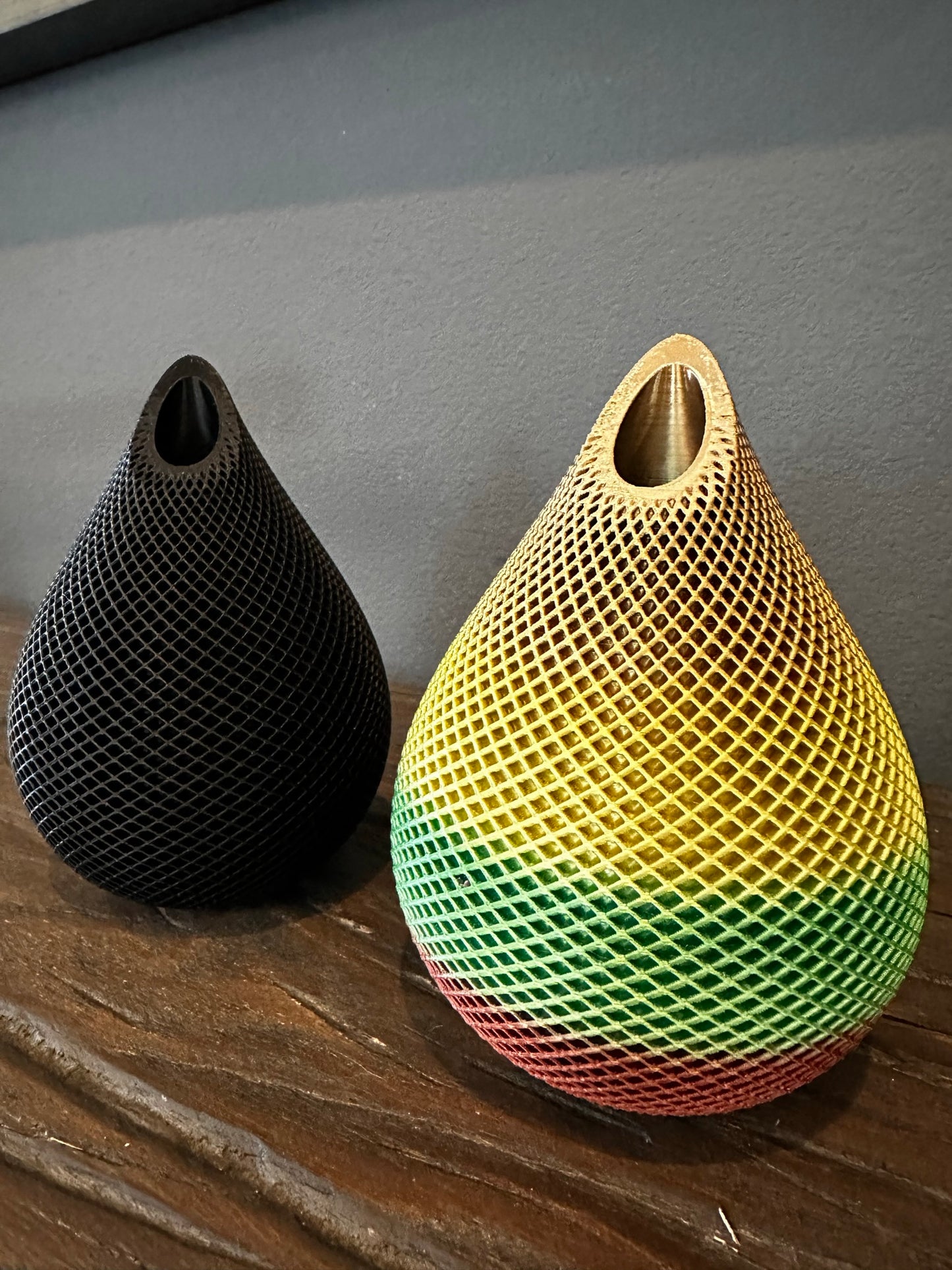 Photo of two Handmade 3D Printed Vases in Black and Rainbow colors with Mesh Pattern