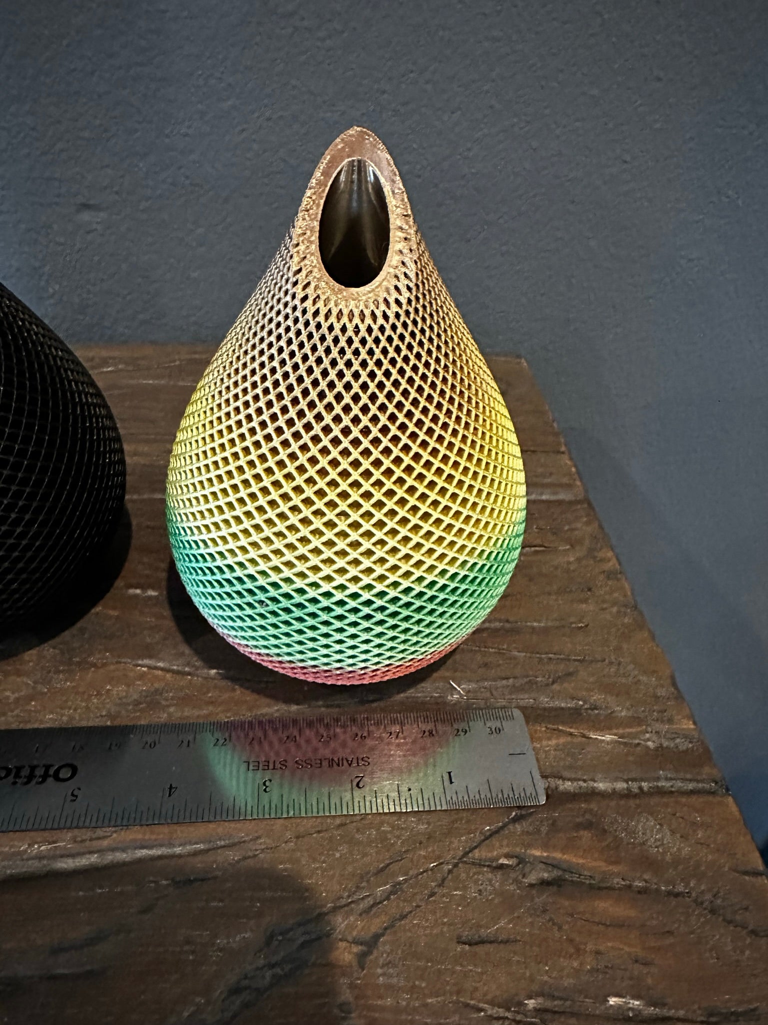 Photo of Handmade 3D Printed Vase in Rainbow Color with Mesh Pattern showing its measurements of approximately 4 inches wide