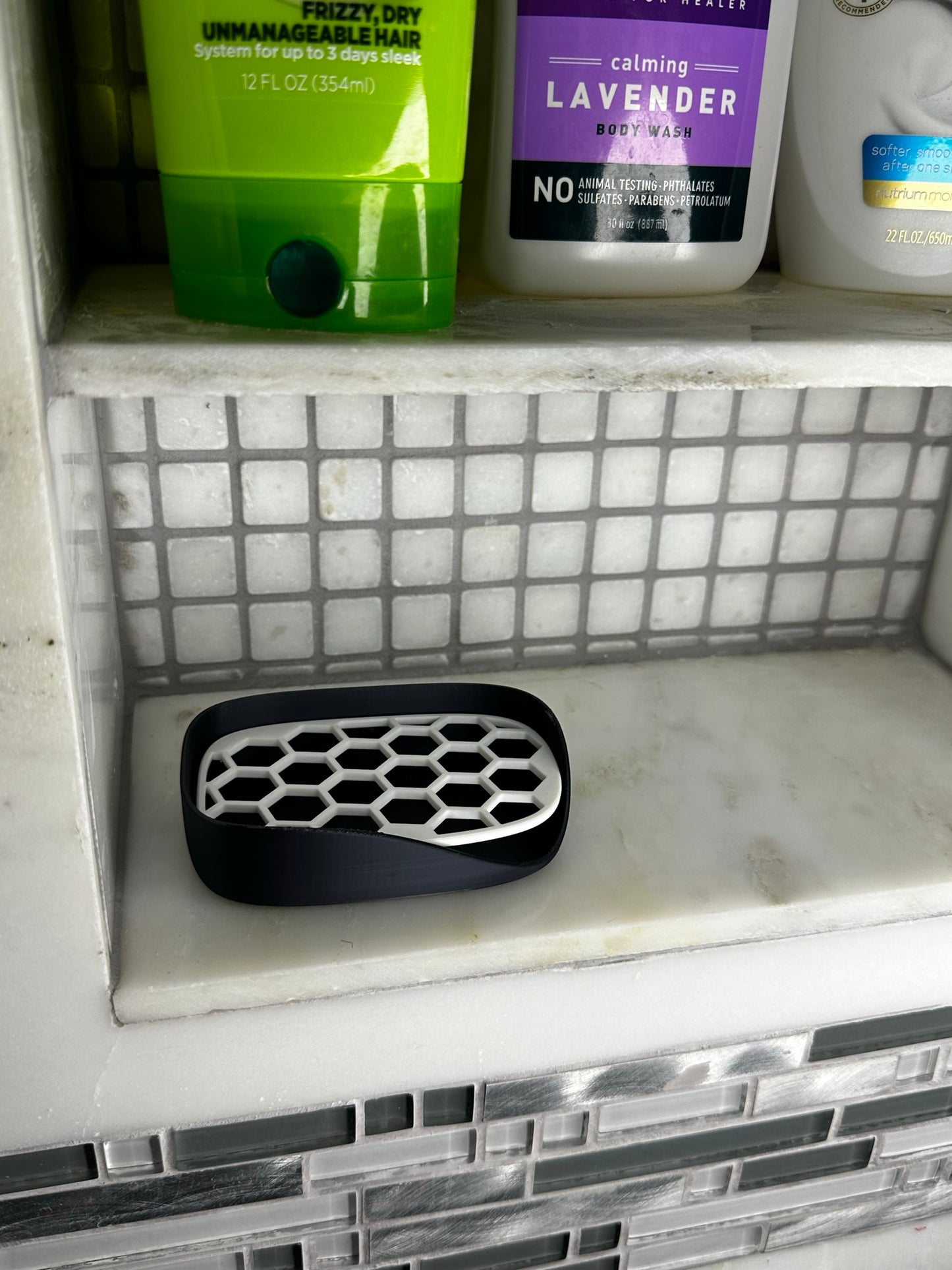 Hexagon pattern soap dish in silky black and white on a bathroom counter