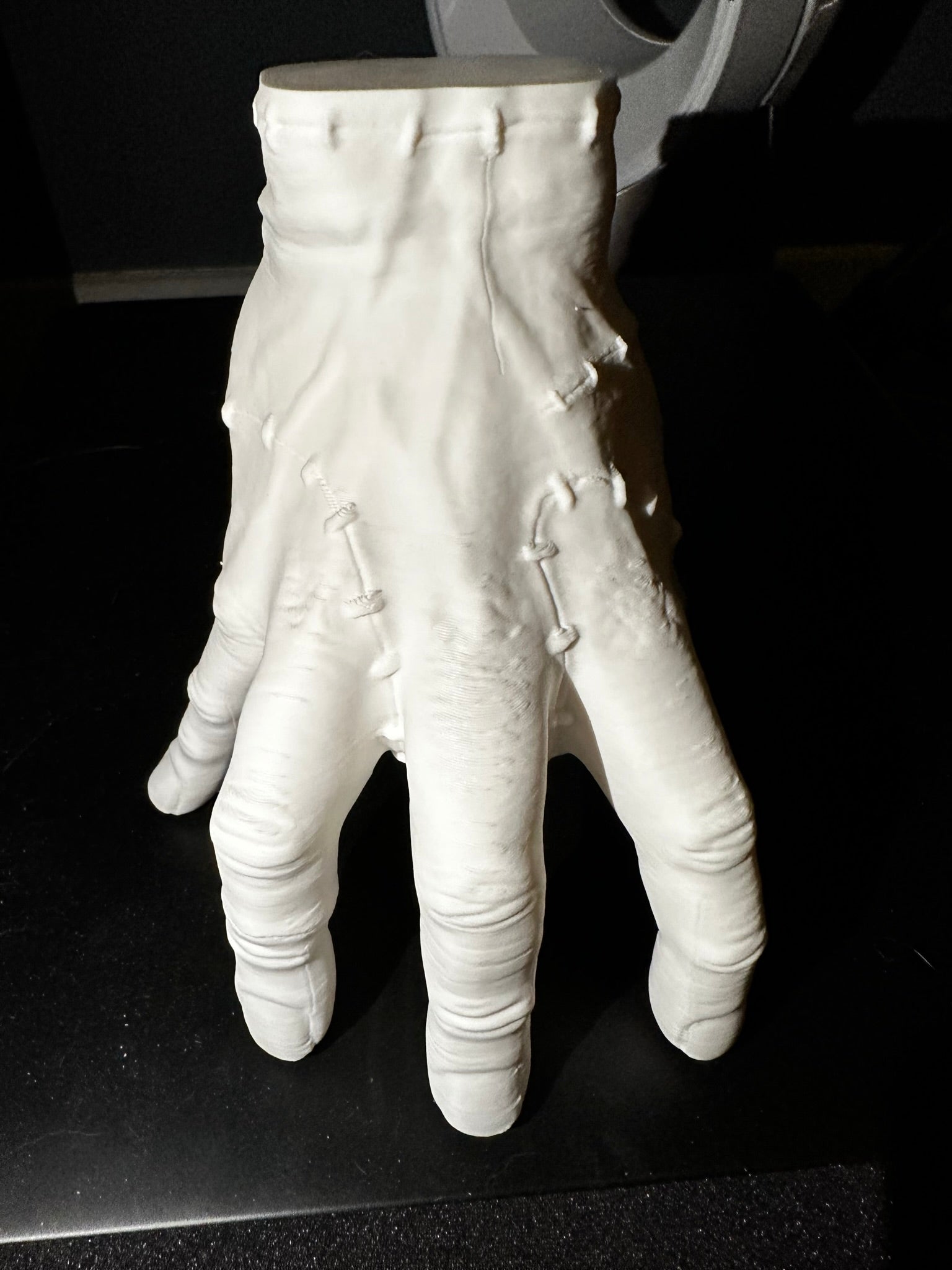 Thing Hand decoration in white on a black surface