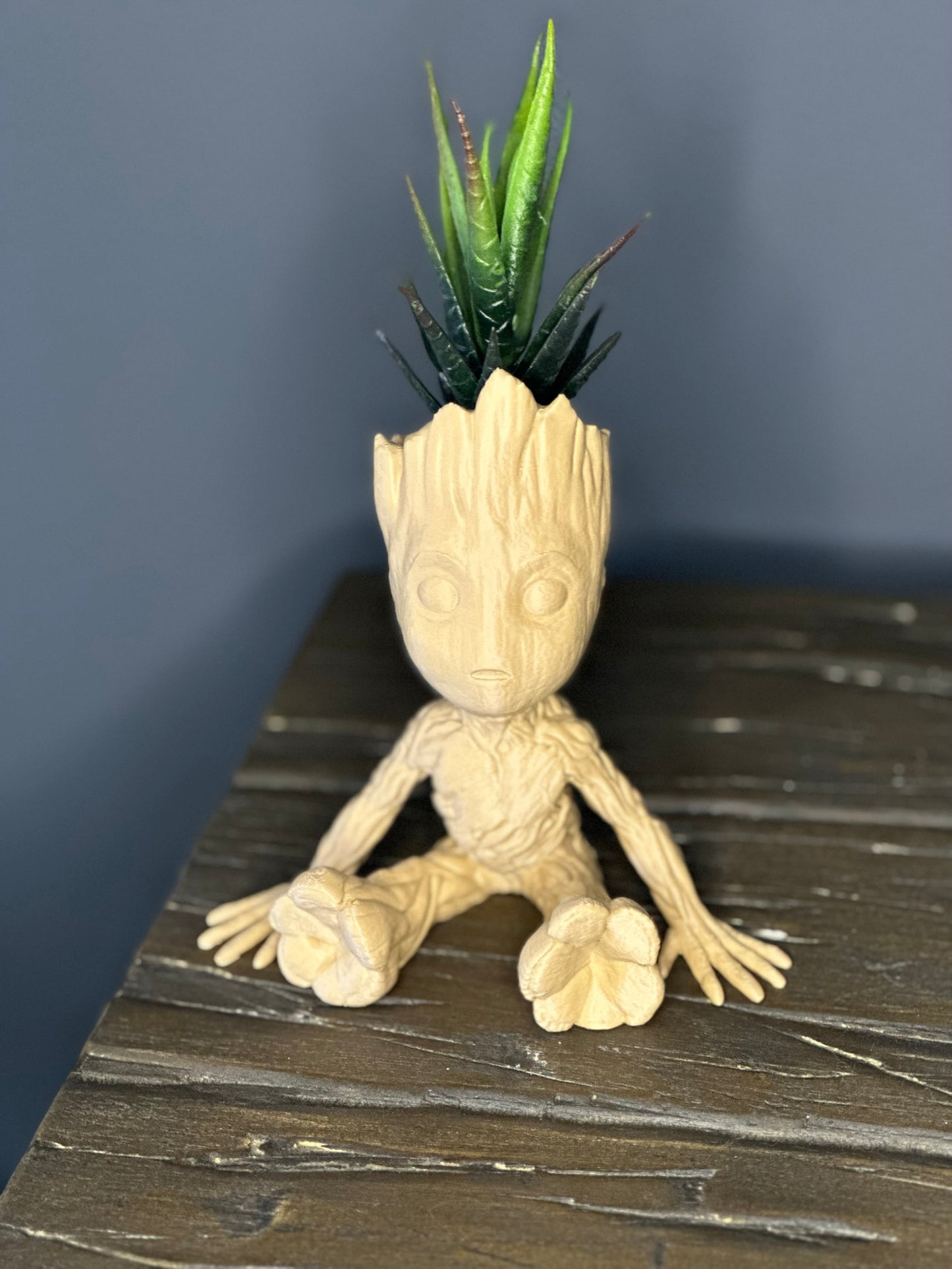 beige baby groot planter with plant in the head