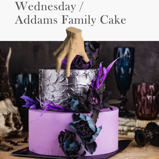 gothic cake inspired by the addams family or wednesday show with THING hand cake topper on top