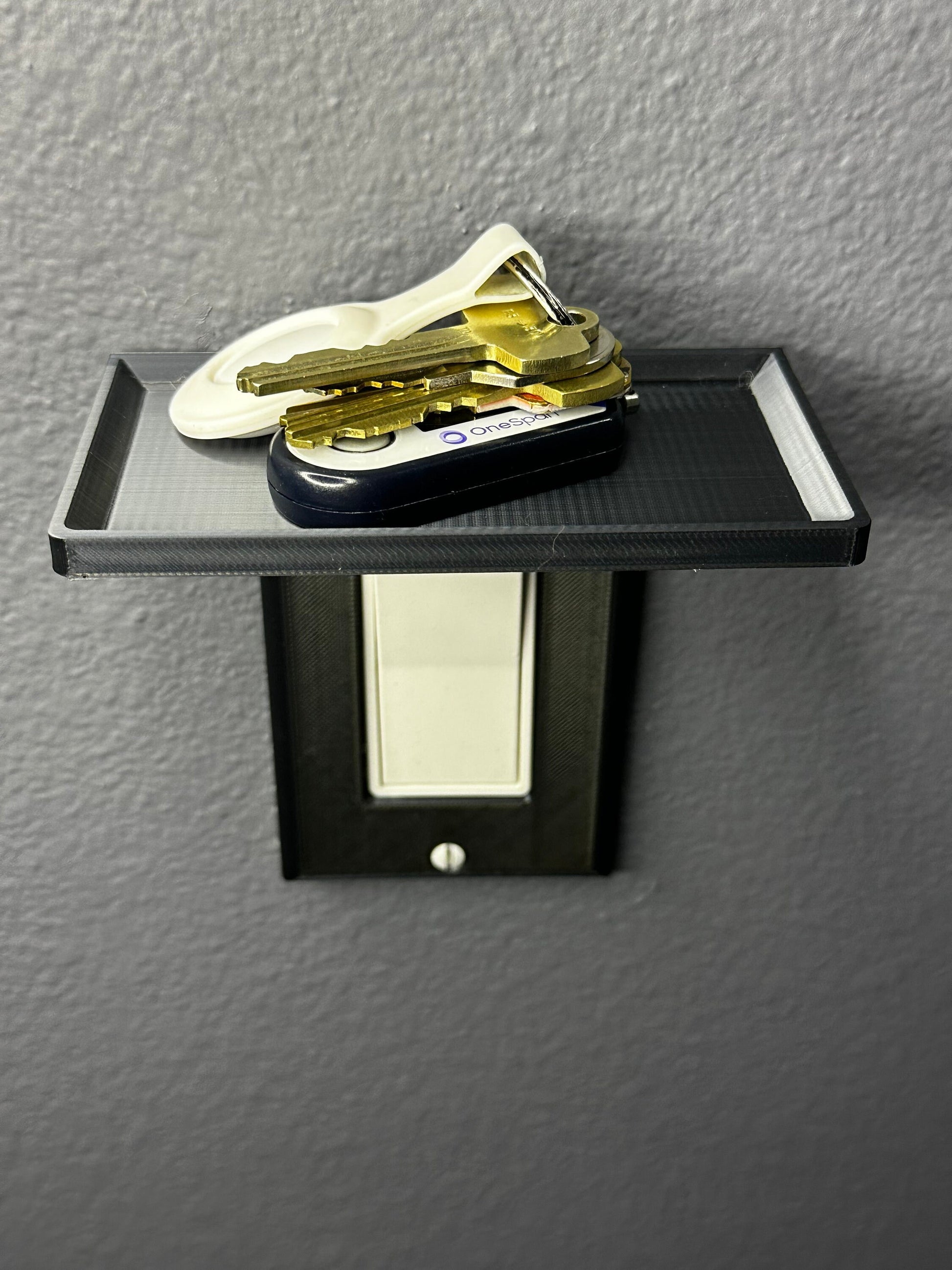 Close-up view of the wall plate with built-in shelf, showcasing the Vertical GFCI Light Switch Plate design