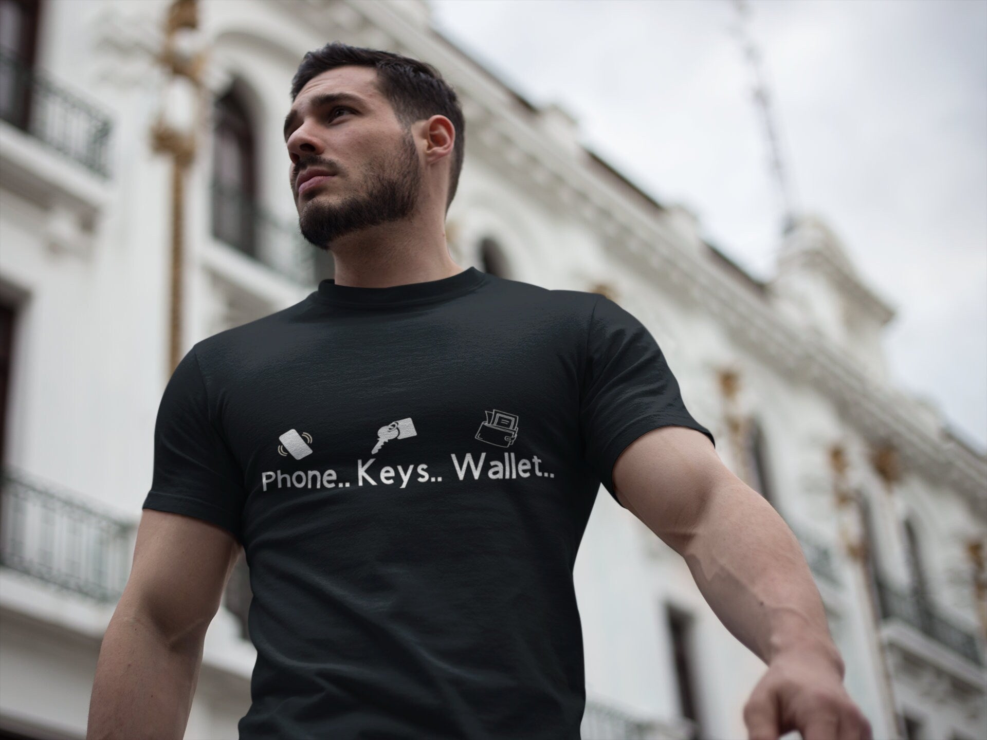 handsome muscular guy wearing the black version of phone keys wallet shirt